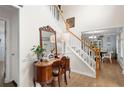 Lovely home entryway featuring hardwood floors, staircase, and beautiful decor at 57 Glenn Eagles Way, Hiram, GA 30141