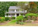Charming two-story home with a welcoming front porch and well-manicured landscaping at 57 Glenn Eagles Way, Hiram, GA 30141