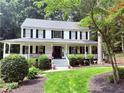Inviting two-story home with classic curb appeal, a covered front porch, and a well-maintained lawn at 57 Glenn Eagles Way, Hiram, GA 30141