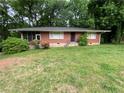 Charming one-story brick home with a well-maintained lawn and mature trees providing a serene setting at 2273 Childress Dr, Atlanta, GA 30311