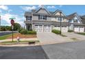Townhome with two-car garage, landscaped lawn, and neighborhood street view at 3552 Clear Creek Nw Xing, Kennesaw, GA 30144