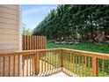 Wooden back deck overlooking a lush green hillside lined with mature trees, providing a private outdoor space at 2419 Ivey Crest Cir, Tucker, GA 30084