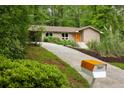 Charming home featuring a stone facade, updated windows, and an eye-catching orange mailbox for added curb appeal at 4228 Durham Cir, Stone Mountain, GA 30083