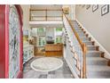 Inviting foyer with a staircase leading to the upper level, complemented by a decorative rug at 1016 Lenox Ne Crst, Atlanta, GA 30324