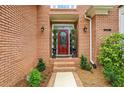 Close-up of the front door and entryway, showing brick facade and decorative landscaping at 1016 Lenox Ne Crst, Atlanta, GA 30324