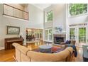 Bright living room with high ceilings, fireplace, and expansive windows offering natural light at 1016 Lenox Ne Crst, Atlanta, GA 30324