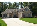 Beautiful home with stone and siding, dormer windows above the garage and a well-manicured lawn at 40 Templeton Ln, Villa Rica, GA 30180