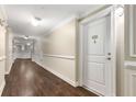 Hallway featuring elegant trim work and wood flooring leading to unit 401 at 200 River Vista Dr # 401, Atlanta, GA 30339