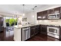 Modern kitchen featuring stainless steel appliances, granite counters, and dark wood cabinetry at 200 River Vista Dr # 401, Atlanta, GA 30339
