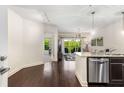Open-concept kitchen with granite countertops and stainless steel appliances flows into a bright living area at 200 River Vista Dr # 401, Atlanta, GA 30339