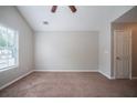Bright bedroom with neutral walls, carpet, ceiling fan, and a window for natural light at 3777 Oakland Spring Ct, Snellville, GA 30039