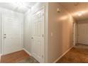 Neutral hallway with hardwood entry, carpet, and white doors at 3856 Vine Stone Dr, Lithonia, GA 30038