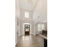Bright foyer featuring soaring ceilings, hardwood floors, and a decorative front door that brings in natural light at 5250 Briarstone Ridge Way, Alpharetta, GA 30022