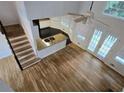 Bright living room featuring wood floors, fireplace and tall windows at 815 Alta Ct, Lithonia, GA 30058
