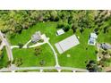 Aerial view of property featuring main house, separate apartment, barn and equestrian riding ring at 1200 Old Lathemtown Rd, Canton, GA 30115