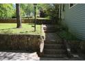 Stone walkway ascends to a home's entrance, bordered by a retaining wall and verdant greenery at 3043 Alston Dr, Decatur, GA 30032