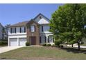 Charming two-story home featuring a well-maintained lawn and inviting facade at 3152 Spruce Way, Atlanta, GA 30349