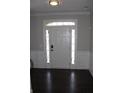Inviting foyer with paneled walls, tiled floor, and a bright white front door with sidelights at 3152 Spruce Way, Atlanta, GA 30349