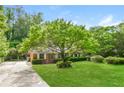 Lovely single-story home enhanced by a mature tree and a well-maintained front lawn at 1237 Gale Dr, Norcross, GA 30093