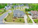 Aerial view of a home in a suburban neighborhood with a private pool and well-maintained landscaping at 2127 Harmony Dr, Canton, GA 30115