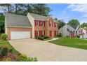 Well-maintained two-story home with brick facade, red shutters, and attached garage at 4805 Wilkie Nw Way, Acworth, GA 30102
