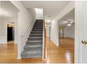 Inviting foyer featuring hardwood floors, a staircase, and views into the living spaces at 4805 Wilkie Nw Way, Acworth, GA 30102