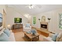 Cozy living room with a fireplace, hardwood floors, and comfortable seating at 2930 Winchester Dr, Cumming, GA 30041