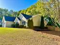 Well-maintained house with landscaped lawn, mature trees and a freshly mulched garden bed at 2536 Caray Ne Ct, Lawrenceville, GA 30043