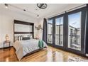 Cozy bedroom featuring hardwood floors, a Murphy bed, and access to a private balcony at 5300 Peachtree Rd # 3601, Atlanta, GA 30341