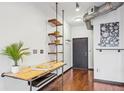 Hallway featuring a custom-built desk, shelving, hardwood floors, and modern industrial design at 5300 Peachtree Rd # 3601, Atlanta, GA 30341
