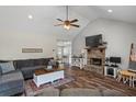 Cozy living room features a stone fireplace, vaulted ceiling, and comfortable seating area at 60 Water Oak Trl, Covington, GA 30014