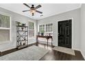 Inviting entryway with dark hardwood floors, natural light, and stylish decor and modern rug at 1076 Firethorne Pass, Cumming, GA 30040
