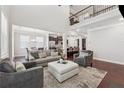 Bright and airy living room with hardwood floors, plush seating, and an open floor plan at 4050 Danbury Farms Dr, Cumming, GA 30040