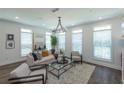 Bright living room featuring lots of natural light and a statement chandelier at 113 Iveybrooke Ln # 61, Alpharetta, GA 30009