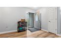 Bright entryway with hardwood floors, complemented by gray walls, front door and featuring a decorative cabinet at 130 Laguna Springs Dr, Woodstock, GA 30188