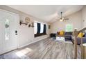 Bright living room features wood floors, a large window seat, and comfortable seating area at 247 Shallowford Nw Rd, Kennesaw, GA 30144