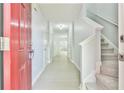 Inviting hallway featuring light gray walls, wood-look flooring and staircase access to the upper level at 6125 Brookechase Ln, Norcross, GA 30093