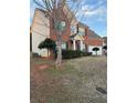 Charming two-story brick home featuring a manicured lawn and a welcoming entrance at 893 Port West Dr, Auburn, GA 30011