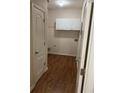 Bright laundry room featuring white cabinets and wood-look flooring at 893 Port West Dr, Auburn, GA 30011