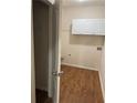 Bright laundry room featuring white cabinets and wood-look flooring at 893 Port West Dr, Auburn, GA 30011