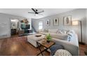 Bright living room featuring a large white sectional, hardwood floors, and modern decor at 15 Swallow Se Dr, White, GA 30184