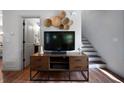 Living room showing a wooden media console and stairs with views into bathroom at 15 Swallow Se Dr, White, GA 30184