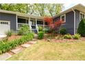 Beautifully landscaped front yard with mature trees and a stone walkway leading to the front porch at 126 N Barton St, Norcross, GA 30071