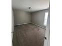 Neutral bedroom with carpet, window, baseboard, and door at 4291 Preserve Trl, Snellville, GA 30039