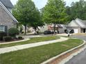 Scenic neighborhood view showcasing lush greenery, well-maintained lawns, sidewalks, and residences nestled among mature trees at 4291 Preserve Trl, Snellville, GA 30039