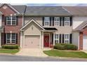 Charming exterior view of a home featuring an attached garage and well-maintained landscaping at 2557 Avery Park Cir, Atlanta, GA 30360