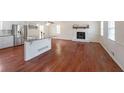 Open-concept living space features a kitchen island, fireplace, and hardwood floors at 3009 Bruce Nw Ct, Acworth, GA 30101