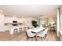 Bright open concept featuring modern kitchen with island, dining area, and cozy living space at 311 Wells Cir, Canton, GA 30114