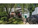 Charming two-story home with siding, brick accents, and an attached one-car garage at 4256 Village Square Ln, Stone Mountain, GA 30083