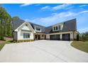 Beautiful exterior of a home with a two car garage, large driveway, white siding and a dark roof at 247 Terrace View Dr, Acworth, GA 30101
